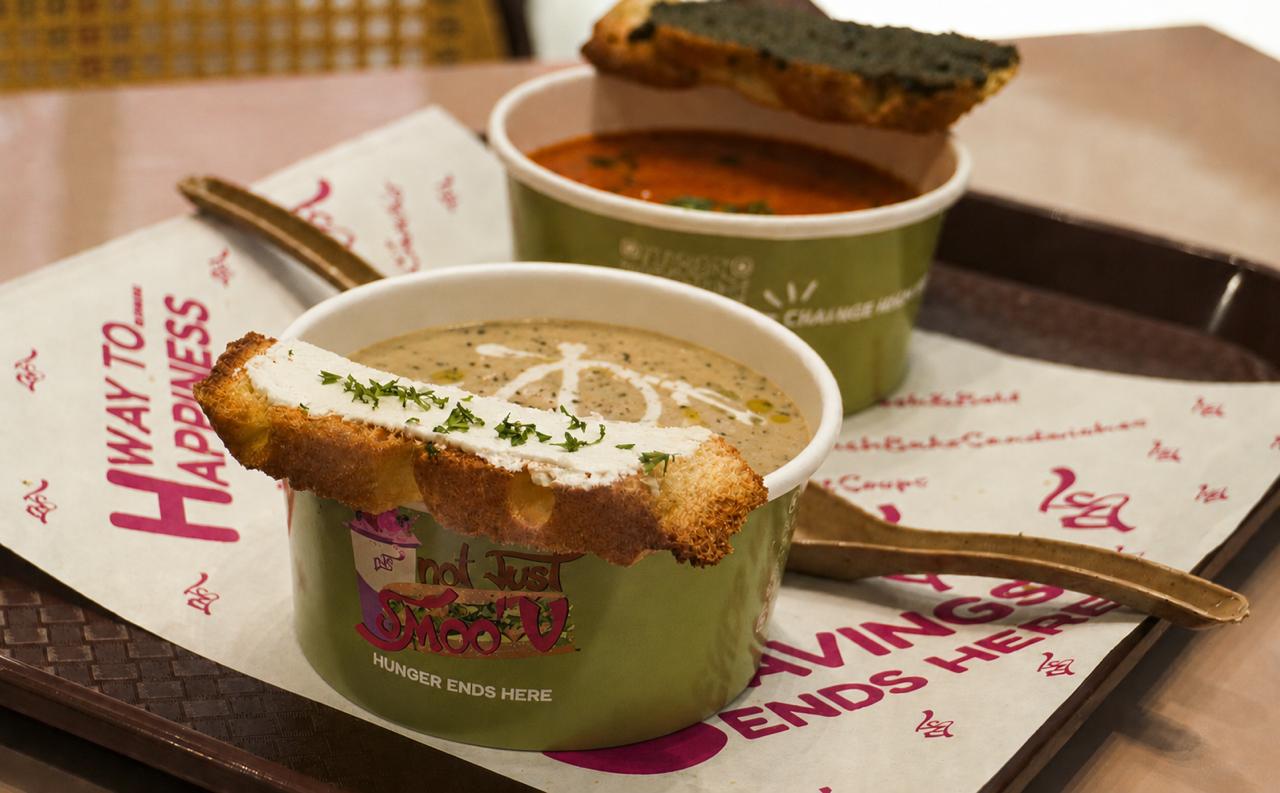 The Soup Duo — OG tomato & wild mushroom, served with parmesan pesto toast and herbed feta toast.